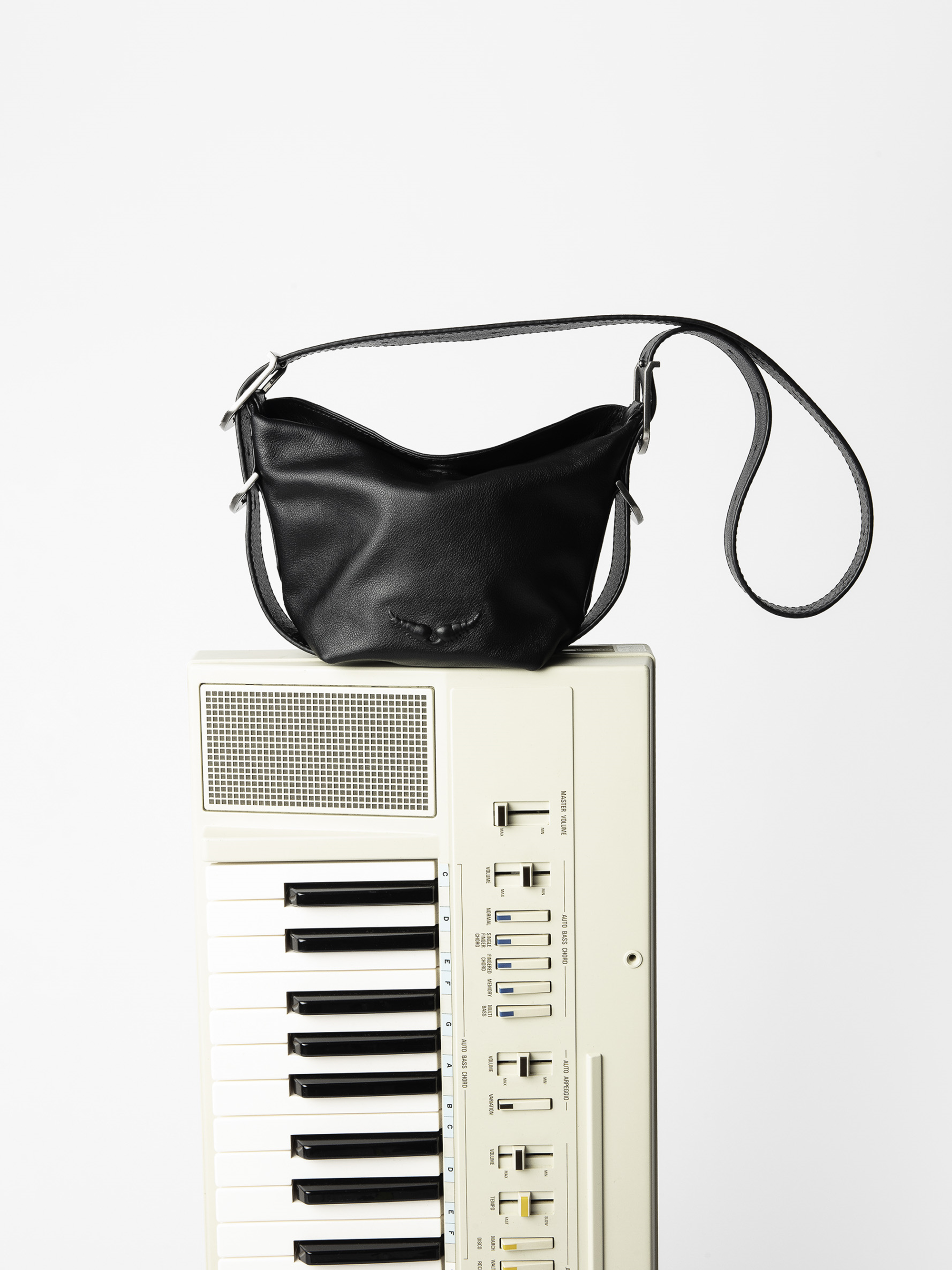 Baby Jane Bag - Leather bag with adjustable shoulder strap and debossed wing signature.